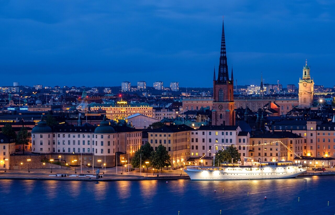city, cityscape, waterfront, illuminated, ship, architecture, skyline, historic center, church, steeple, nature, water, sea, night, evening, twilight, lights, mirroring, stockholm, sweden, scandinavia
